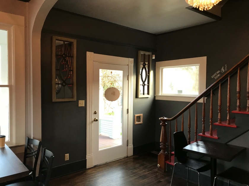 Just inside tell for coffee is a beautiful staircase leading to the second floor.   One of my favorite features is the wide white trim and dark green painted walls